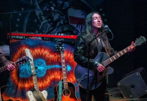 Great shot of Johnny and his guitars against the backdrop of our latest single, I Still Believe In America!