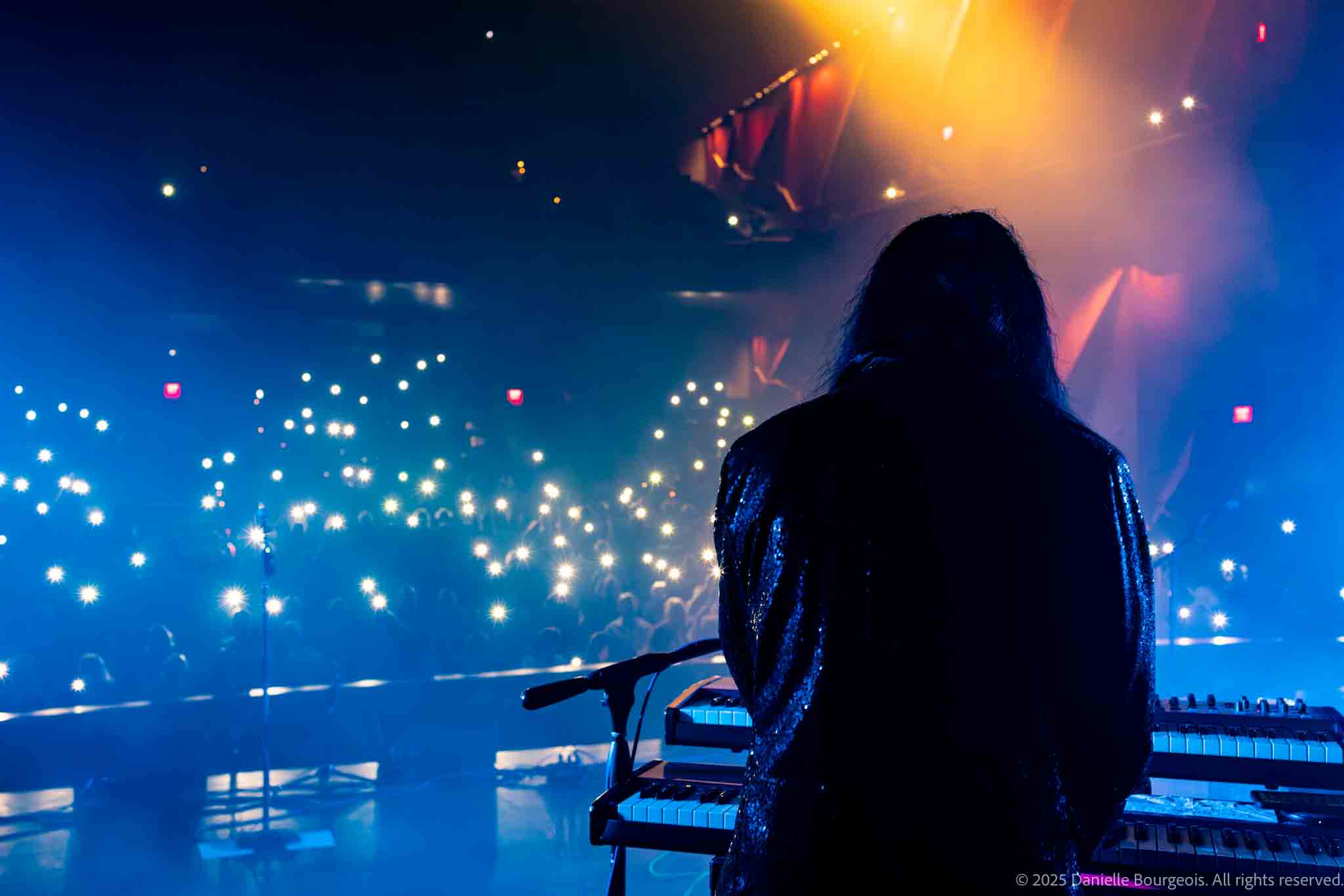 Johnny Ono of Already Gone gazes out at a sea of glowing cell phones held aloft by the audience